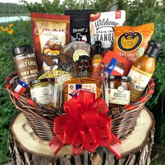 a basket filled with lots of food and condiments on top of a tree stump