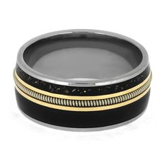 a black and gold wedding ring with two bands on the inside, set against a white background