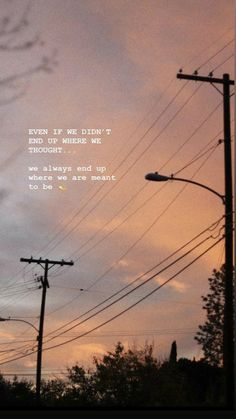 the sky is filled with power lines and telephone poles that are silhouetted against an evening sky