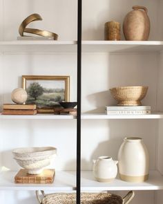 white shelves with vases and other items on them