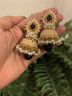 A unique jhumka with clustered micro pearls with a black centre teardrop stone. Care Instruction: Avoid heat & substances like perfume, deodorant, alcohol, etc and clean with silver/gold polish cloth. Store in airtight spaces like ziplock pouch or jewelry box. Black Jewellery Set, Luxury Festive Jhumkas With Stone Work, Elegant Black Jhumkas For Festive Occasions, Black Bollywood Jhumkas For Festivals, Black Chandbali Jhumkas For Party, Black Jhumkas As A Gift, Elegant Black Jhumkas With Latkans, Black Bollywood Jhumkas With Latkans, Black Festive Jhumkas For Festivals