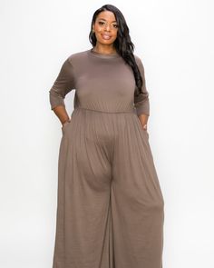 Take a stylish mock neck tee and pair it with straight leg pants and you've got a stellar jumpsuit to wear day and night. This knit one-piece has deep pockets on the leg, and an elasticated back waistband. Get ready to go out with the girls or date night with this fun plus-size romper L I V D Sienna Jumpsuit | Mocha | Dresses | Materials & Care Instructions: ['100% Polyester', 'Machine wash', 'Made in USA'] Wide Jumpsuit, Mocha Dress, Dresses Materials, Plus Size Romper, Jumpsuit Chic, Jumpsuit Black, Plus Size Jumpsuit, Care Label, Wide Leg Jumpsuit