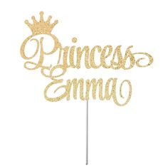 a cake topper with the word princess on it and a crown in gold glitter