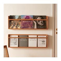 two wooden shelves with books and magazines on them