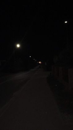 a dark street at night with no cars on it