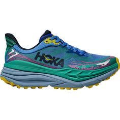 Now with softer foam, a smoother rocker, and a touch of stability, the HOKA Stinson ATR 7 Trail Running Shoe keeps our daily singletrack miles steady, letting us sink into our flow. With supportive H-frame technology and raised sidewalls, the platform minimizes heel deviation on strikes and shifting inside the shoe on uneven terrain, keeping our transitions smooth and stable no matter how technical the terrain gets. Atop wet rocks and soft dirt, the sticky rubber and multi-directional lugs bite Blue Running Shoes With Gel Cushioning For Outdoor, Green Running Shoes With Gel Cushioning For Outdoor, Green Trail Running Shoes With Cushioned Footbed, Outdoor Green Running Shoes With Gel Cushioning, Hoka Tennis Shoes, Frame Technology, Hoka Shoes, Mens Trail Running Shoes, Slip And Slide