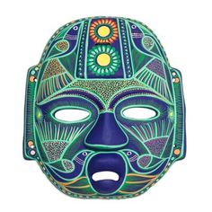 a blue mask with green and yellow designs on it's face, against a white background