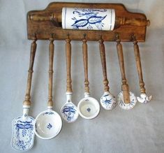 an old wooden rack with spoons hanging from it