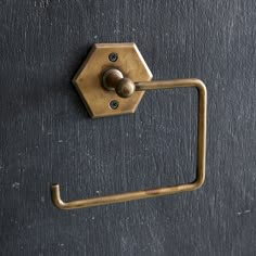 a metal handle on a black door with a hexagonal shape and round knob