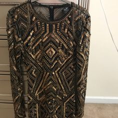 a black and gold dress hanging on a rack