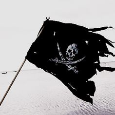 a pirate flag is flying in the wind