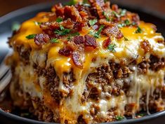 a slice of cheeseburger casserole on a plate with a fork in it