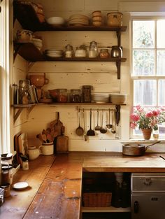 a kitchen with wooden counters and shelves filled with pots and pans