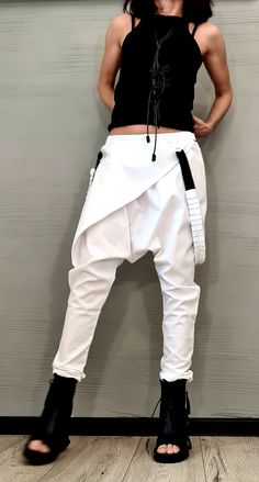 "Avant Garde Pants, White Harem Pants Women, Drop Crotch Pants, Extravagant Pants, Casual Pants, Urban Pants ❤️ Extravagant designs and high quality fabrics! ❤️ Materials & Care Textile, Polyamide, Cotton Hand wash at low temperatures. Do not machine dry. Do not iron. Do not dry clean! ❤️ Sizing We can make your piece from XS to 5XL! Everything in the shop can be also made according to your measures free of charge! ❤️ Shipping ✈ Ready to ship The time I need to prepare an order for shipping Fitted White Harem Pants With Pockets, White Baggy Harem Pants, White Stretch Harem Trousers, White Harem Bottoms For Spring, White Baggy Harem Bottoms, White Baggy Ankle-length Cargo Pants, Avant Garde Pants, Drop Crotch Pants Women, White Harem Pants