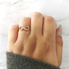 M A T E R I A L S ~ Solid Sterling Silver ~ 18k Rose Gold Vermeil S T O N E S Cruelty Free ~ Simulated Diamond Flawless / Colorless ~ Total Stones : 0.26ct total D I M E N S I O N S ~Infinity Sign: 7mm ~ Band: 2.4mm R I N G C A R E ~ Simple instructions to care for the ring is not expose your jewelry to chemicals like bleach, chlorine, hairspray, to avoid chemical reactions or breakdown of materials. (Just as you would with any jewelry) ~ Try not wear your jewelry in the shower or to bed to avoi Rose Gold Infinity Jewelry For Promise, Rose Gold Infinity Promise Jewelry, Minimalist Rose Gold Infinity Ring, Adjustable Infinity Promise Ring, Hypoallergenic Rose Gold Infinity Jewelry, Infinity Shape Stackable Fine Jewelry Rings As Gift, Fine Jewelry Infinity Stackable Rings As Gift, Fine Jewelry Stackable Infinity Rings As Gift, Dainty Infinity Rose Gold Rings