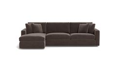 a brown sectional couch with pillows on it