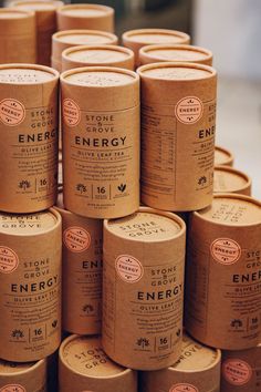 many rolls of energy tea are stacked on top of each other in brown paper boxes