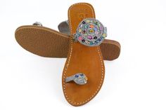 Moroccan bridal sandals, we bet to make it the best to compliment your outfit. Be the star woman by wearing this pair of beautiful leather Beaded sandals which hold the manufacturing perfection of Ethnic Arts. These summer sandals have multicolor striped embroidery work. The brown insole makes these women's flip flop slippers even unique to wear. These Wedding sandals look best when teamed with your daily outfits. Made from high quality material, these are comfortable and durable. You can carry Leather Sandals With Embellished Single Toe Strap, Embellished Leather Sandals With Single Toe Strap, Leather Sandals With Rhinestones And Flat Heel, Leather Flat Heel Sandals With Rhinestones, Wedding Leather Sandals With Rhinestones, Stone Embellished Round Toe Sandals For Summer, Leather Sandals With Rhinestones And Single Toe Strap, Leather Rhinestone Open Toe Sandals, Leather Sandals With Rhinestones For Beach