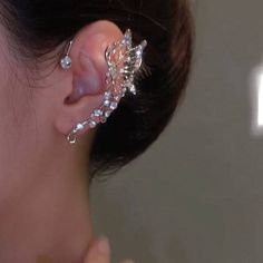 a close up of a person wearing an ear cuff