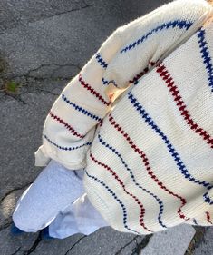 the back of a person's sweater with red, white and blue stripes