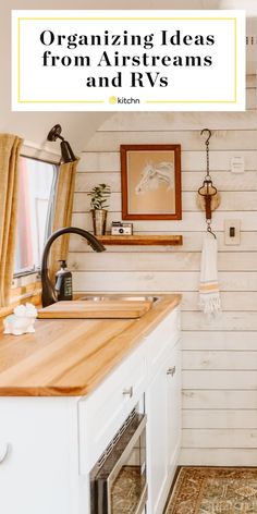 a kitchen with white walls and wood floors