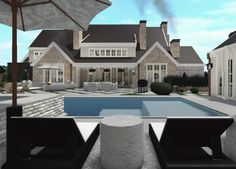 a large house with a swimming pool in the middle and two lounge chairs next to it