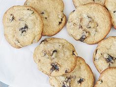 chocolate chip cookies sitting on top of a white plate