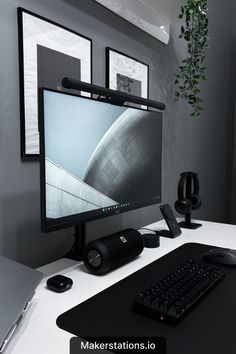 a desktop computer sitting on top of a white desk next to a keyboard and mouse