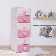 a pink and white chest of drawers in a child's room with stuffed animals