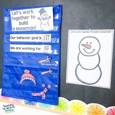 a bulletin board with snowmen on it next to a sign that says let's work together to build a snowman