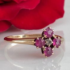 Details: Super sweet Victorian ring with diamond and pink/red rubies. The setting reminds me of flower. The ring is 14K rose gold, and has been tested. There are no markings on the interior of the band. There are four 3.25mm rubies and one 2mm diamond. Please ask all necessary questions prior to placing an order. Measurements: The size is 7 1/4 US and can be sized for a fee. Condition: The overall all condition of this ring is very good. Fine Jewelry Pink Ruby Ring With Single Cut Diamonds, Formal Rose Gold Ruby Ring With Rose Cut Diamonds, Vintage Pink Diamond Ring Hallmarked, Victorian Pink Ruby Ring For Anniversary, Vintage Pink Diamond Ring With Hallmark, Pink Ruby Ring With Single Cut Diamonds, Pink Ruby Ring In 14k Gold For Anniversary, Pink Victorian Ruby Ring For Anniversary, 14k Rose Gold Ruby Ring For Anniversary