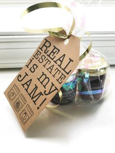 some jars are wrapped in plastic and sitting on a window sill next to a tag