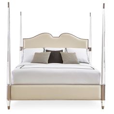 a white bed with four posts and two pillows on it's headboard, in front of a white background