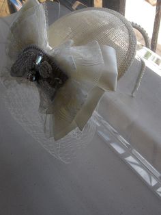 This Ivory Ribbon Lace Crystal Bow Sinamay Fascinator Hat with Veil and Pearl Headband is a beautiful accessory for weddings, bridesmaid, parties, and other special occasions. It is elegant, stylish, romantic, and super chic! Will definitely add a sparkling touch to your outfit!! I only accept PayPal and ship all orders within 24 hours via USPS. Feel free to send me a convo with any questions. Thank you for visiting Hettie Hair Accessories! Elegant Bridal Accessories With Satin Bow, Elegant Cream Hat With Bow, Elegant Wedding Hats With Ribbon, Elegant Wedding Hats With Satin Bow, Elegant Wedding Hat With Bow, Adjustable Hats With Bow For Wedding, Adjustable Wedding Hats With Bow, Elegant Beige Wedding Headpieces, Elegant Headband Fascinator For Ceremony