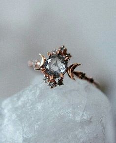 a diamond ring sitting on top of a rock