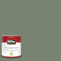 a can of behr paint and primer in one on a dark blue background