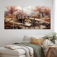 a living room with a white couch and paintings on the wall above it, along with a coffee table