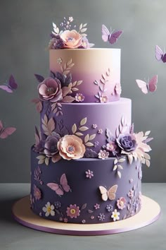 a three tiered cake decorated with purple flowers and butterflies