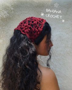 a woman with long black hair wearing a red crochet headband on her head