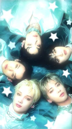 four young men are laying in the middle of a star - shaped photo with their eyes closed