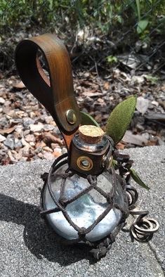 a metal object sitting on top of a rock