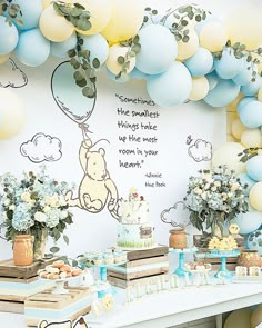 a winnie the pooh themed birthday party with balloons and desserts on a table