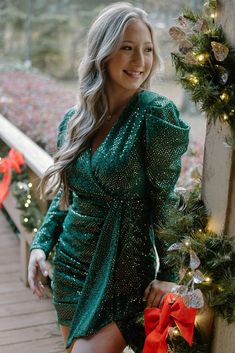 Emerald Up To Something Dress You could definitely be up to somethin' in this dress! Hit all of the holiday parties and any night out will be memorable in this stretchy and fully-lined stunner. The glittering green fabric is sparkle from top to bottom, but it is also covered with tiny gold tone sequins that give it an overall gold sheen. The set elastic waistband and ruching on the skirt hug the body. The plunging neckline is perfect for displaying the newest jewelry. The zippered back keeps the Fitted V-neck Sequin Dress For Festive Occasions, Green Fitted Dress For Party Season, Fitted Green Dresses For Party Season, Green Glitter Fitted Dress, Holiday Party Sequin Dress With Shimmer, Fitted Green Glitter Dress, Green Sequined Mini Dress For Cocktail, Cocktail Green Mini Dress With Sequins, Green Fitted Dress With Glitter Details