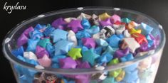 there is a glass bowl filled with small colorful stars on the bottom, and one in the middle