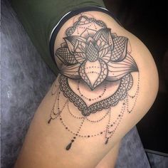 a woman's thigh with a black and white tattoo design on the side of her leg