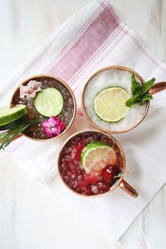 three bowls filled with different types of drinks and garnishes on top of a table