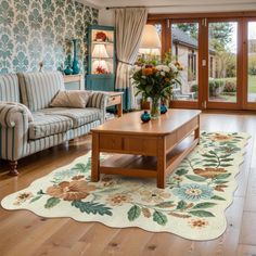 a living room filled with furniture and flowers on the table in front of a sliding glass door