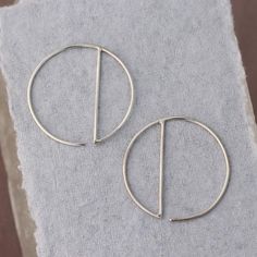 • Sterling Silver Geometric Hoop Earrings -- silver circles with a vertical dividing line, super minimalist and easy to wear• READY TO SHIP • Just over one inch long and wide Minimalist Sterling Silver Round Threader Earrings, Minimalist Silver Linear Earrings For Everyday, Everyday Minimalist Silver Linear Earrings, Minimalist Metal Hoop Earrings, Minimalist Open Circle Hoop Earrings, Minimalist Sterling Silver Hoop Earrings, Minimalist Round Linear Earrings For Everyday, Nickel-free Minimalist Round Linear Earrings, Minimalist Nickel-free Round Linear Earrings