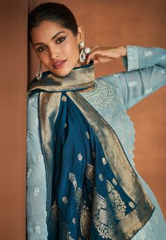 COLOR : Light Blue & Cyprus Blue FABRIC : Top & Bottom - Pure Georgette, Inner - Silk Santoon, Dupatta - Pure Banarasi Jacquard WORK : Resham & Zari Embroidery, Woven Zari, Stones, Sequins, Motifs, Lace BorderOCCASION : Wedding, Reception, Mehendi, Engagement, Party Wear, Festival READY-TO-WEAR : No STITCHING : Available as semi-stitched fabric, can be stitched using standard size option (+$20). Note: There might be a slight color variation due to lighting and flash used during photoshoot. The b