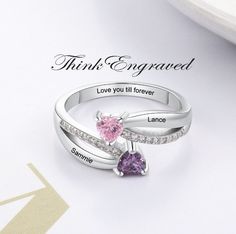 Personalized 2 Stone Mother's Ring Heart Birthstones 2 Engraved Names This ring is made of .925 sterling silver. You can choose 2 engraved names and 2 birthstones. Enter like this, please- Birthstone 1- Name 1- Birthstone 2- Name 2- Inner engraving-  Names must be 10 characters or less and inner engraving 18 characters or less We hand-make this piece once the order is placed.  This takes 3-5 business days during the normal time of year but can take up to 10 business days if it is the holiday sea Silver Rings With Name Engraving For Valentine's Day, Personalized Silver Rings For Valentine's Day, Sterling Silver Name Rings For Valentine's Day, Personalized Sterling Silver Engraved Ring For Valentine's Day, Personalized Sterling Silver Ring For Valentine's Day, Personalized Heart-shaped Silver Birthstone Ring, Personalized Silver Heart-shaped Birthstone Ring, Customizable Silver Engraved Ring For Mother's Day, Personalized Engraved Silver Ring For Valentine's Day